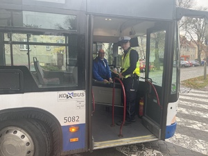 policjant z kierowcą autobusu w autobusie